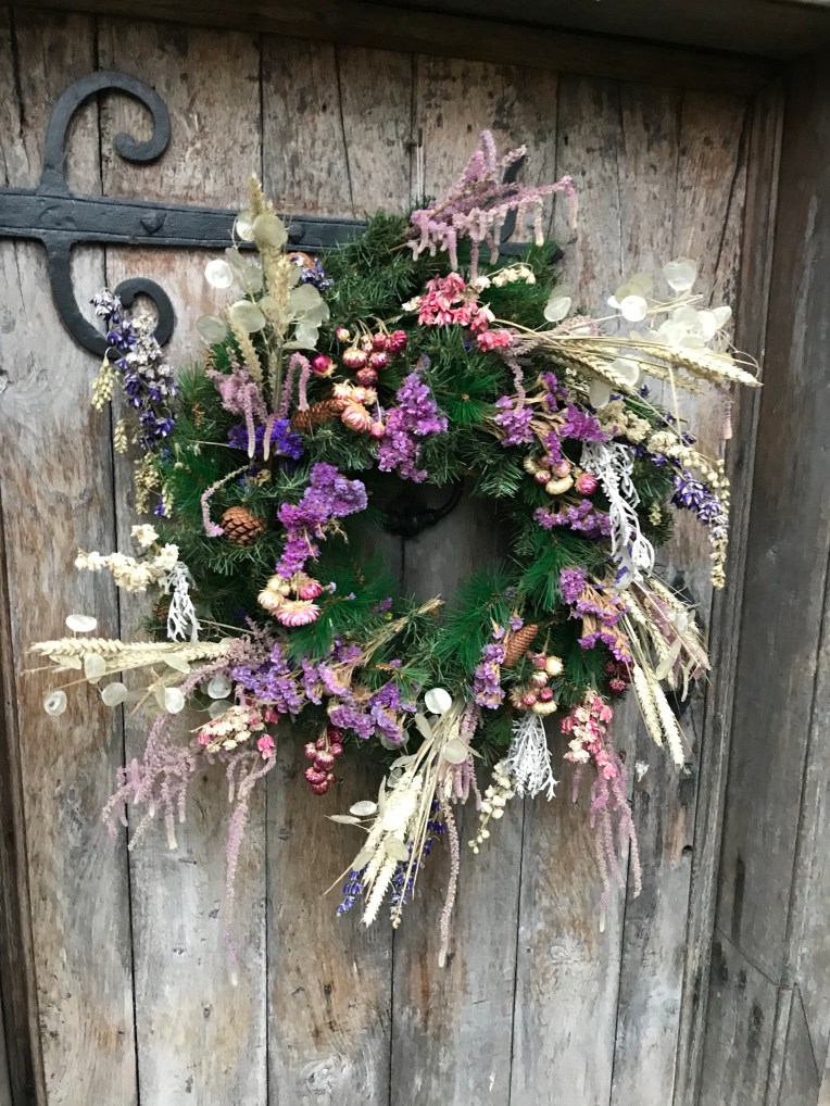 Christmas wreath on an old oak door at a Baddesley Clinton, Warwickshire.